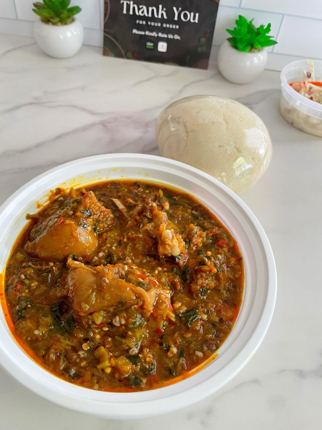Egusi soup served with poundo yam