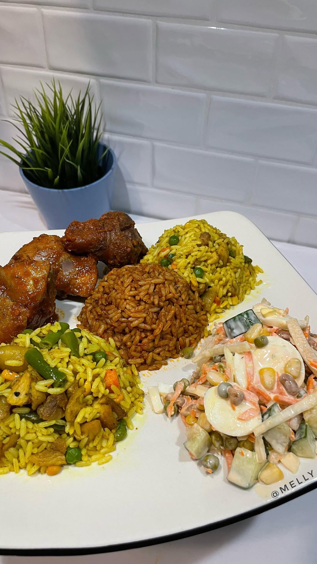 Fried rice and jollof plate with chicken and coleslaw